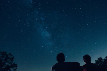 silhouette photo of two person watching stars silhouette photo of two person watching stars