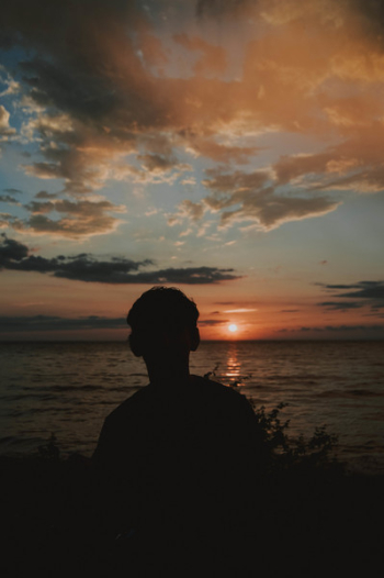 Silhouette Photography of Man Near Body of Water Silhouette Photography of Man Near Body of Water