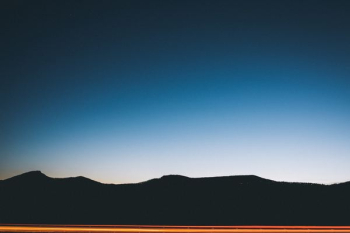 silhouette photography of mountain at blue hour silhouette photography of mountain at blue hour