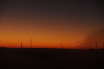 silhouette photography of wind mills silhouette photography of wind mills