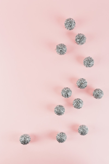 Silver Christmas decorations on a pink background Silver Christmas decorations on a pink background