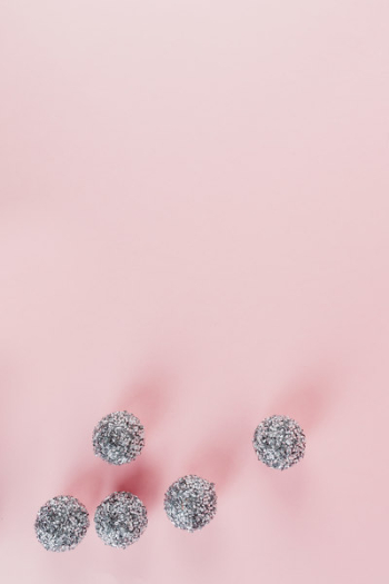 Silver Christmas decorations on a pink background Silver Christmas decorations on a pink background
