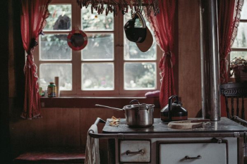 silver pot near window silver pot near window