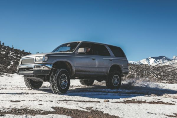 silver SUV on snow mountain silver SUV on snow mountain