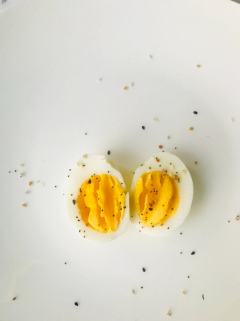 Sliced Boiled Egg on White Plate Sliced Boiled Egg on White Plate