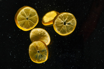 Sliced of Lemons on Black Surface Sliced of Lemons on Black Surface