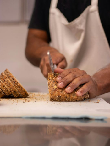 Slicing Freshly Baked Artisan Bread Slicing Freshly Baked Artisan Bread