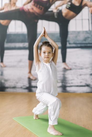 Small innocent girl doing yoga at gym Free Photo Small innocent girl doing yoga at gym Free Photo