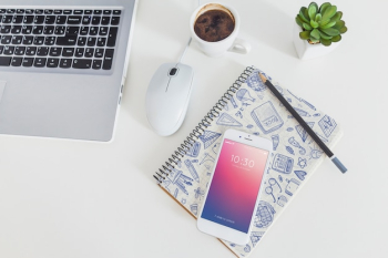 Smartphone mockup with laptop and workspace concept