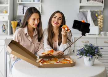 Smiley women taking selfie while eating Free Photo