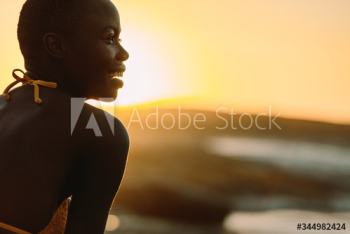 Smiling african woman on the beach at sunset Smiling african woman on the beach at sunset