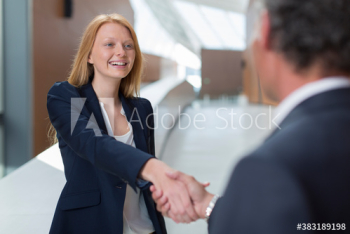 Smiling business people shaking hands Smiling business people shaking hands