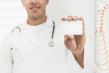 Smiling doctor showing card mock up Free Photo