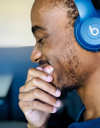 Smiling Man Using Blue Beats Headphones Smiling Man Using Blue Beats Headphones