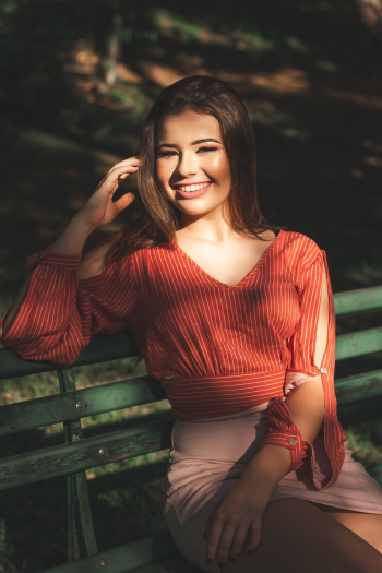 Smiling Woman Sitting Alone on Bench