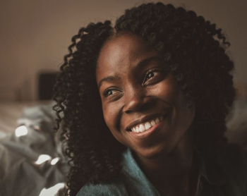 smiling woman wearing gray collared top