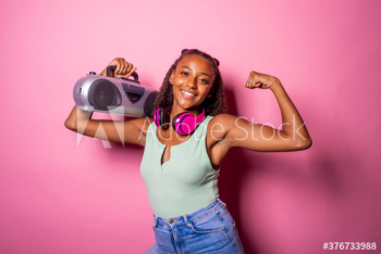 Smiling young woman holding stereo and showing biceps Smiling young woman holding stereo and showing biceps