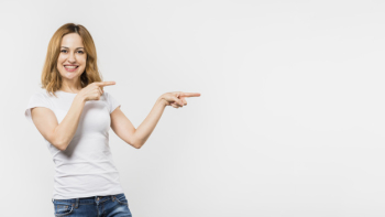 Smiling young woman pointing the fingers isolated on white background