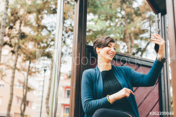 Smiling young woman taking selfie outdoors Smiling young woman taking selfie outdoors