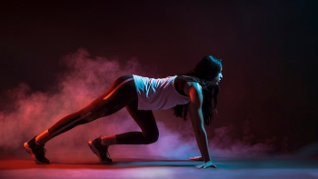 Sportswoman on crouch start in dark Sportswoman on crouch start in dark