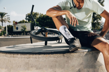 Sporty man standing near a bmx bike Free Photo