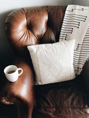 square white throw pillow on brown leather sofa chair square white throw pillow on brown leather sofa chair