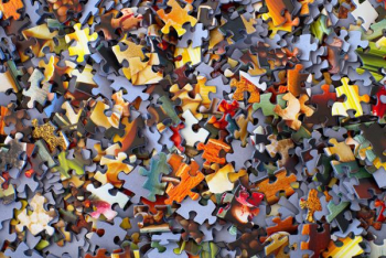 stack of jigsaw puzzle pieces stack of jigsaw puzzle pieces