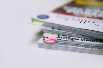 Stack of white magazines with copy space Stack of white magazines with copy space