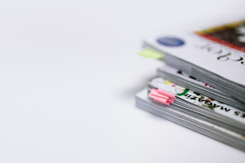 Stack of white magazines with copy space Stack of white magazines with copy space