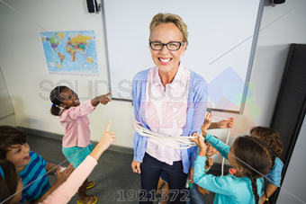 Stock Photo of Laughing blonde female teacher with glasses bound ...