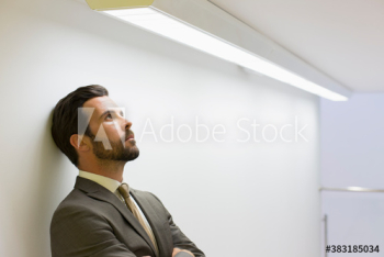 Stressed corporate businessman looking up Stressed corporate businessman looking up