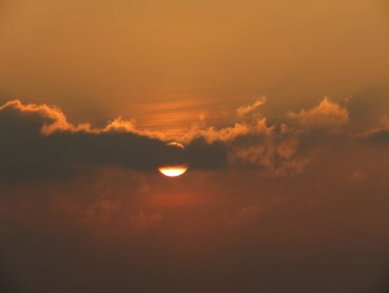 sun covered by clouds at sunset sun covered by clouds at sunset
