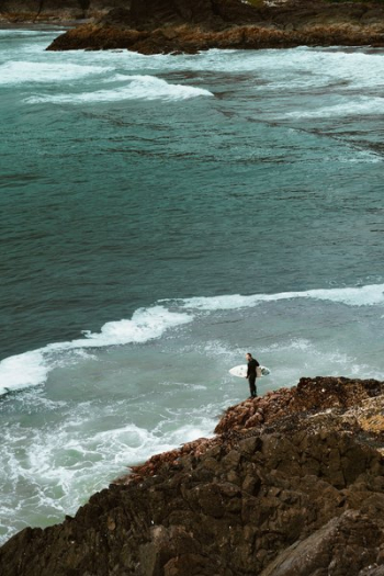 Surfer By Rocks Surfer By Rocks
