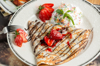 Sweet crepe with powder and strawberries Free Photo Sweet crepe with powder and strawberries Free Photo