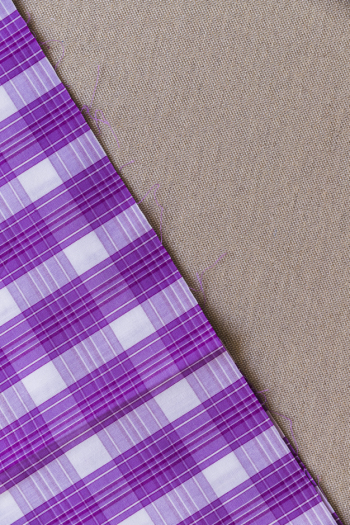 Tartan plaid fabric on plain textile Tartan plaid fabric on plain textile