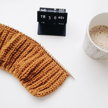 teacup beside knitted cloth teacup beside knitted cloth