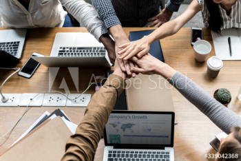 Team of business people stacking hands Team of business people stacking hands