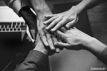 Team of business people stacking hands Team of business people stacking hands