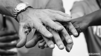 Team of business people stacking hands Team of business people stacking hands