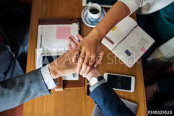 Team of business people stacking hands Team of business people stacking hands