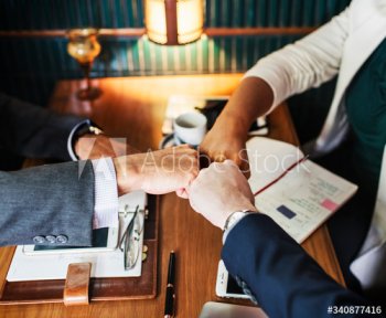 Team of business people stacking hands Team of business people stacking hands