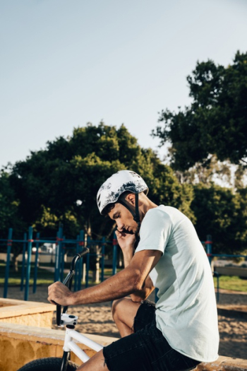 Teenage bmx rider standing on his bike medium shot Free Photo