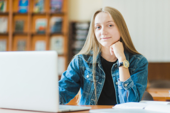 Teenager with laptop looking at camera Teenager with laptop looking at camera