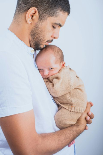 Tender Moment Between Father and Newborn Tender Moment Between Father and Newborn