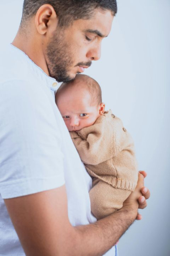 Tender Moments: Father Holding Newborn Baby Tender Moments: Father Holding Newborn Baby