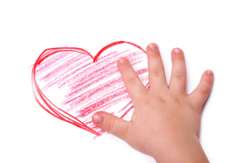 The children's hand is located in heart drawing, isolated
