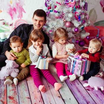 The father with children sitting near Christmas Tree The father with children sitting near Christmas Tree