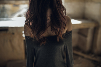 The girl bowed head and dropped her hair The girl bowed head and dropped her hair