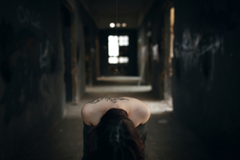 The girl bowed head in the gloomy aisle The girl bowed head in the gloomy aisle