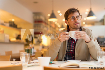 Thoughtful man drinking coffee in cafe